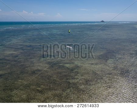 Kiteboarding, Kite Surf. Extreme Sports Kitesurfing In Tropical Blue Ocean, Clear Beach. Aerial View