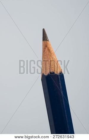 Tip Detail Of Black Pencils On A Little Blue Background.
