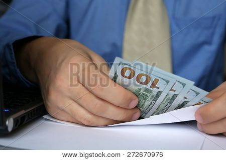Envelope With Dollars In Male Hands, Close-up. Man In Business Clothes Takes The Money Cash, Concept