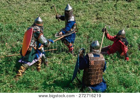 Luh, Russia - August 27, 2016: Reconstruction Of Medieval Battle Of Knights In Armor And Weapons At 