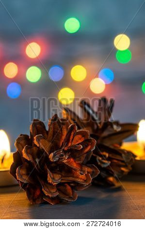 Christmas Or New Year Decorations And Burning Candles On A Dark Background. In Magic Candle Light. B