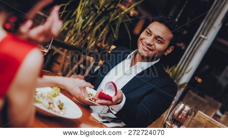 Hispanic Handsome Man Proposing To Girlfriend. Romantic Couple In Love Dating. Cutel Man And Girl In