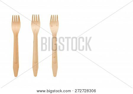 Three Wooden Forks On A White Isolate Background In The Left Part Ob The Frame. Plugs From Natural M