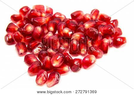 Red Heart Of Grenades. Big Ripe Red Granets Or Garnets. Fruits Of Red Ripe Pomegranate On The White