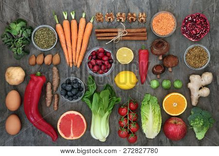 Health food to slow ageing process concept including fruit, vegetables, spices and herbs used in herbal medicine Very high in antioxidants, anthocyanins, dietary fibre & vitamins. Top view on marble.