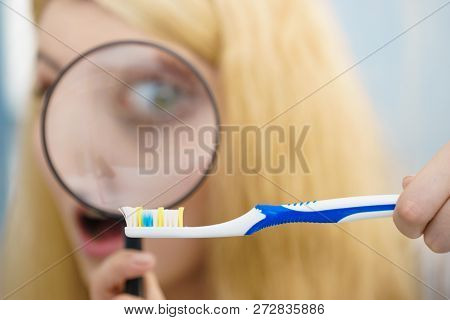 Beautiful Perfectionist Young Woman Checking Her Tooth Brush Through Manifying Loupe Glass. Hygiene,
