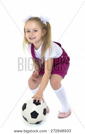 Adorable Little Girl With A Soccer Ball. The Concept Of Childrens Sports, Summer Outdoor Recreation.