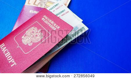 Passports On The Blue Background. Citizenship Of Estonia And Russia. Citizenship Of European Union (
