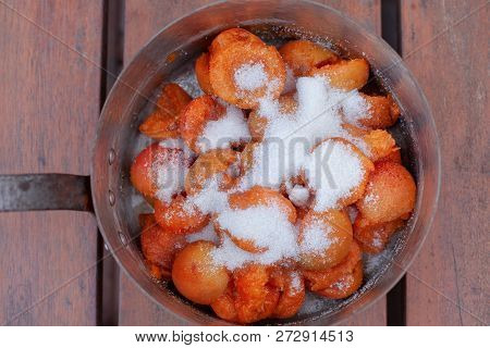 Fresh Bright Orange Appricotes Covered With Sugar On The Copper Jar, Settled On The Natural Wooden T