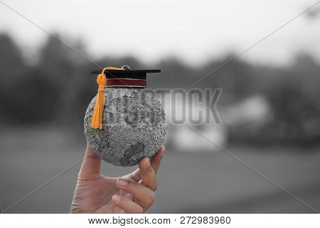 Education World Knowledge Ideas. Graduation Cap On Students Holding Gray Paper Mache Craft Earth Glo