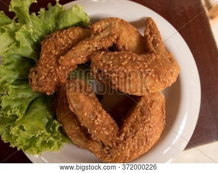 Fried Chicken On A White Plate Set On A Wood Table