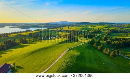 Aerial View Over Lake Forggensee At The City Of Fuessen In Bavaria Germany