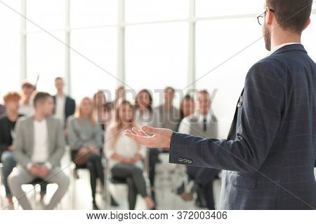 close up. speaker standing in front of the audience in the conference room