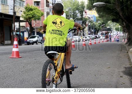 Salvador, Bahia / Brazil - September 22, 2013: Child Is Seen Riding A Bicycle In The City Of Salvado