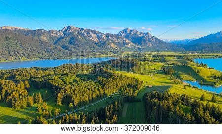Aerial View Over Lake Forggensee At The City Of Fuessen In Bavaria Germany