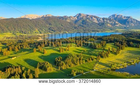 Aerial View Over Lake Forggensee At The City Of Fuessen In Bavaria Germany