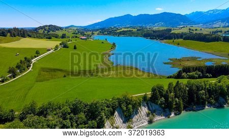 Aerial View Over Lake Forggensee At The City Of Fuessen In Bavaria Germany