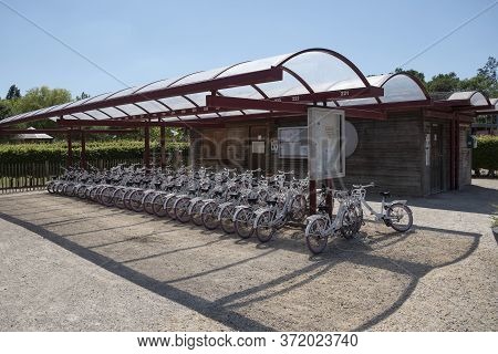 Puyenbroeck, Belgium, May 30, 2020, Many White Bicycles For Rent In A Covered Bicycle Shed