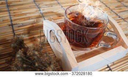 Hot Tea In Clear Glass On A Woven Wooden Floor