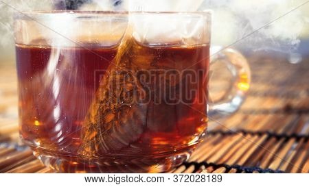 Hot Tea In Clear Glass On A Woven Wooden Floor