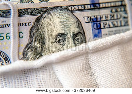 A Hundred-dollar Bill With A Medical Mask .the Concept Of Coronavrius Epidemic