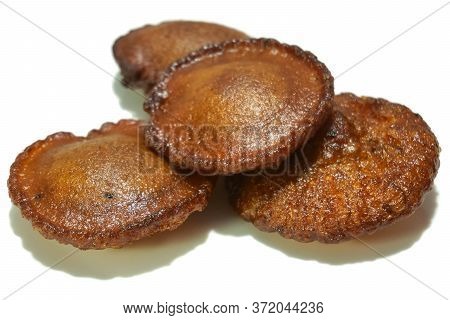 Traditional Sweet Snack From Kerala Called Neyyappam Isolated On A White Background. It's Made Of Ri