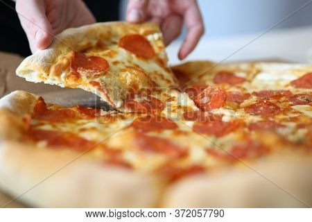 Close-up Of Person Taking Slice Of Bright Pizza. Yummy Double Cheese Mozzarella Parmesan And Baked T