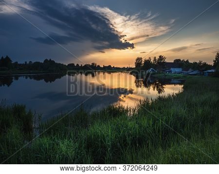Sunset Over The River. Pudost Village. Russia.