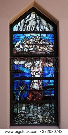 PIFLAS, GERMANY - JUNE 07, 2015: God gives people new life, stained glass window by Sieger Koder in church of Saint John in Piflas, Germany