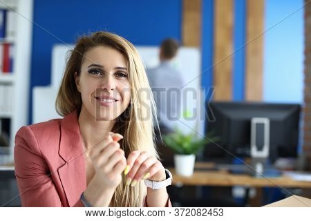 Portrait Of Lovely Smiling Lady Sitting At Work. Working Hours. Beautiful Blonde Woman Posing For Pi