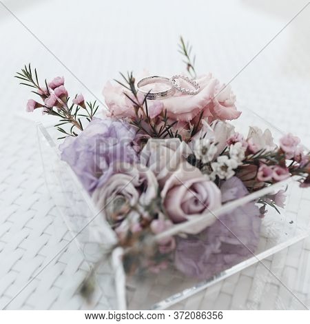 Wedding Rings Close Up Photo In Wedding Box With Flowers