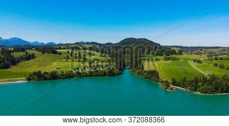 Aerial View Over Lake Forggensee At The City Of Fuessen In Bavaria Germany