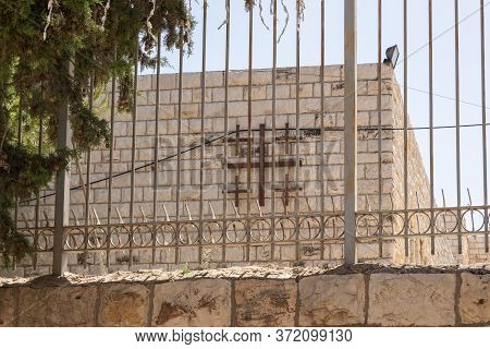 Jerusalem, Israel, June 13, 2020 : Large Metal Cross On The Wall Of Memorial Monument For Hospitalle
