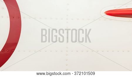 Silver Metal Surface Of The Aircraft Fuselage With Rivets. Fuselage Detail View. Airplane Metallic F