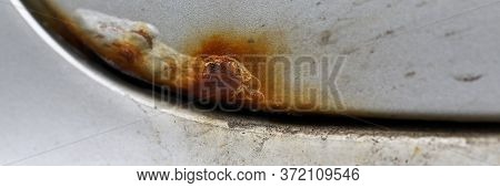 Close Up Corrosion, Old Rusty Stain On Hood Car. Damage To Protective Coating Metals. Car Service. C