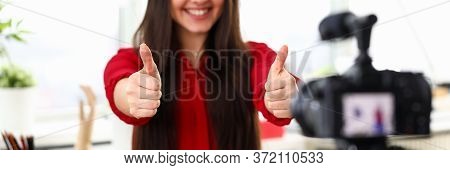Office Worker Girl Showing Ok In Front Camera. Girl Sitting In Front Camera Smiles On Blog. Girl Wel