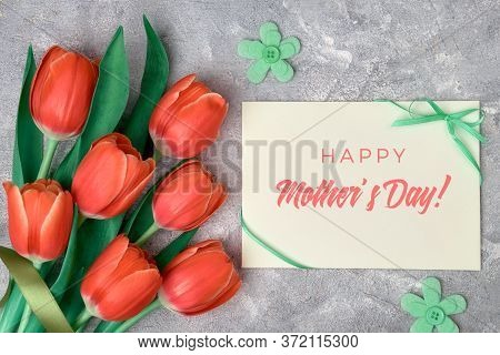 Happy Mothers Day, Text On Paper Card With Ribbon Bow. Flat Lay With Red Tulips, Green Textile Flowe
