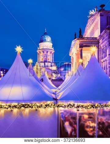 Romantic Evening View Of Lit Canvas Tents And Illuminated Historical Buildings Of Chtristmas Market 