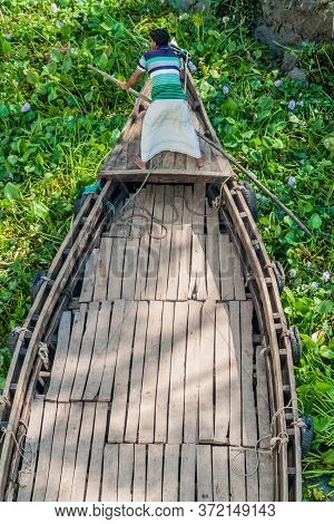 Katcha River, Bangladesh - November 19, 2016: Local Man On A Small Boat Stuck In A Vegetation On Kat
