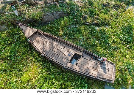 Katcha River, Bangladesh - November 19, 2016: Two Men On A Small Boat Stuck In A Vegetation On Katch
