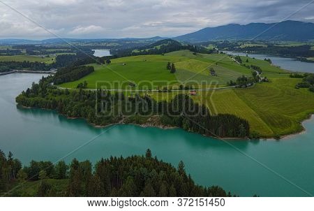 Aerial View Over Lake Forggensee At The City Of Fuessen In Bavaria Germany