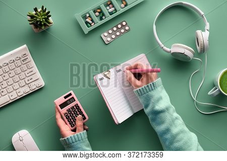 Flat Lay With Notebook To Monitor Drug Costs. Hands With Pen And Calculator. Various Pills And Pill 