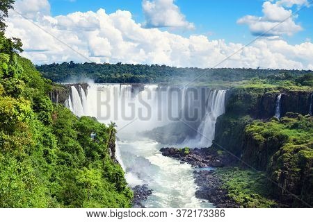 Iguazu Waterfalls In Argentina, View From Devils Mouth. Panoramic View Of Many Majestic Powerful Wat