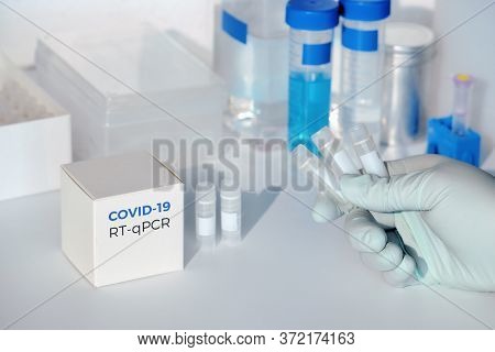 Hand With Test Tubes For Novel Covid-19 Coronavirus In Medical Samples. Rt-pcr Kit Is Used To Make D
