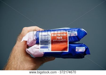 Paris, France - Aug 7, 2019: Pov Male Hands Holding Fresh Toilet Wet Paper Manufactured By Tempo Feu