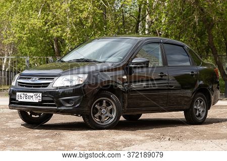 Novosibirsk/ Russia - May 02 2020: Black Lada Granta, Popular Sedan  Car Parked Outdoors On A Warm S