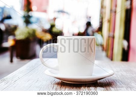 Cup Of Coffee In The Street Or Outdoors At Coffee Shop Or Cafe With Blurred Background