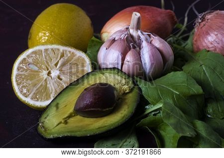 An Avocado With Garlic, Lemon, Arugula And Onion