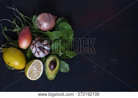 An Avocado With Garlic, Lemon Arugula And Onion