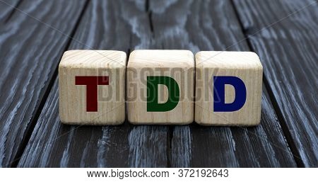 Concept Word Tdd On Cubes On A Beautiful Gray Blue Background